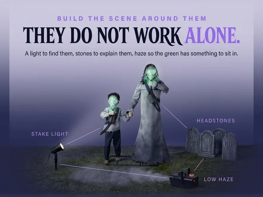 Dusk arrangement: the pair with a stake spotlight, foam headstones and a small fog machine on the same ground.