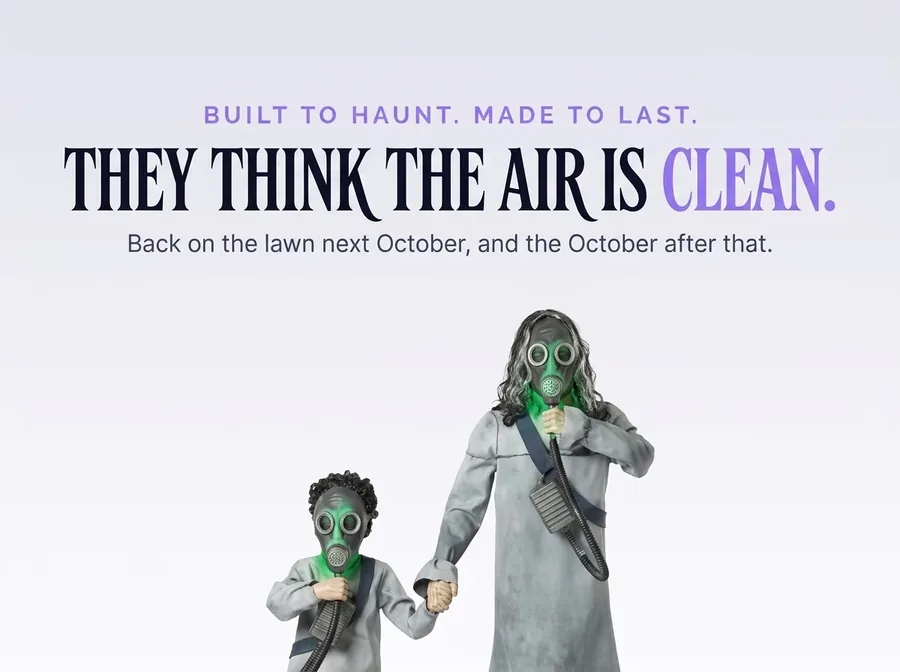 The pair cut out low on an off-white ground with their faces lit green, under the line They think the air is clean.