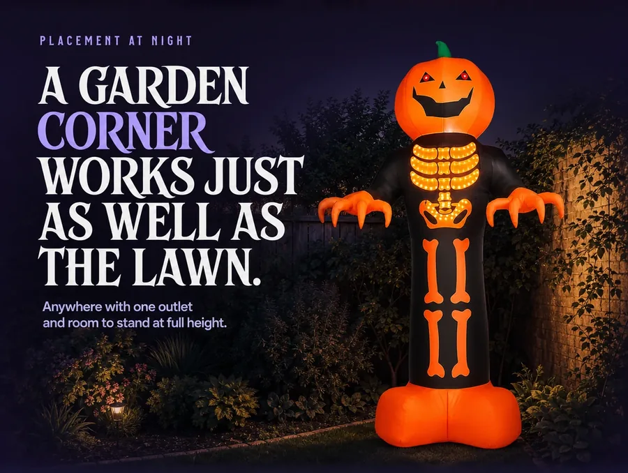 The reaper staked in a garden corner at night, its glow catching the nearby shrubs.