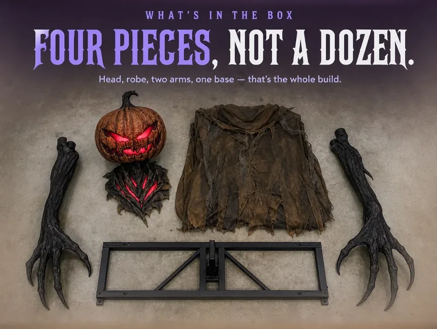Overhead flat-lay of the figure's disassembled parts: head, folded robe, two arms and a metal base.