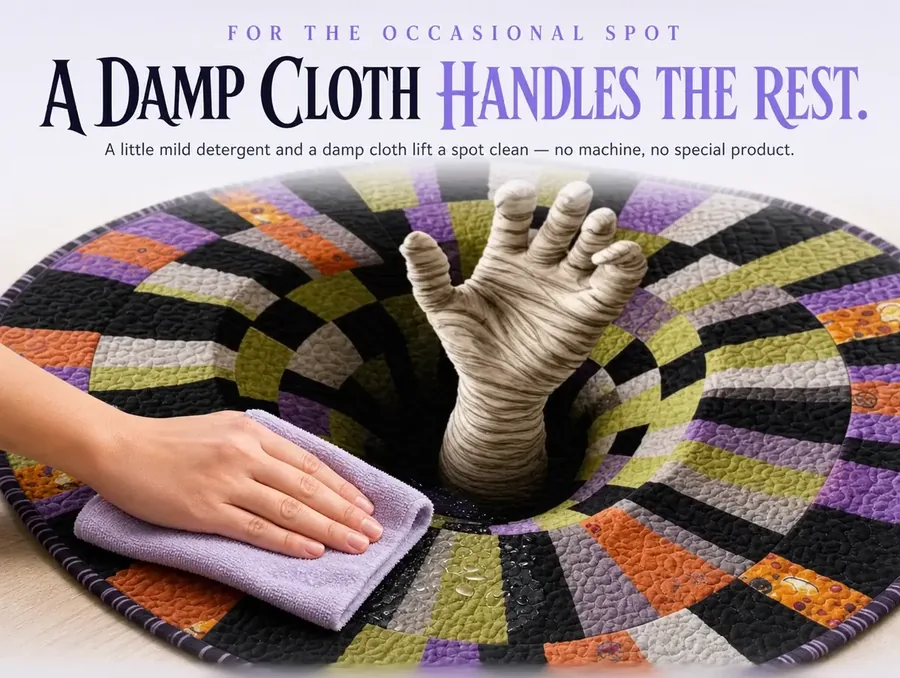 Close-up of a damp cloth being used to spot-clean a section of the checkerboard illusion rug.